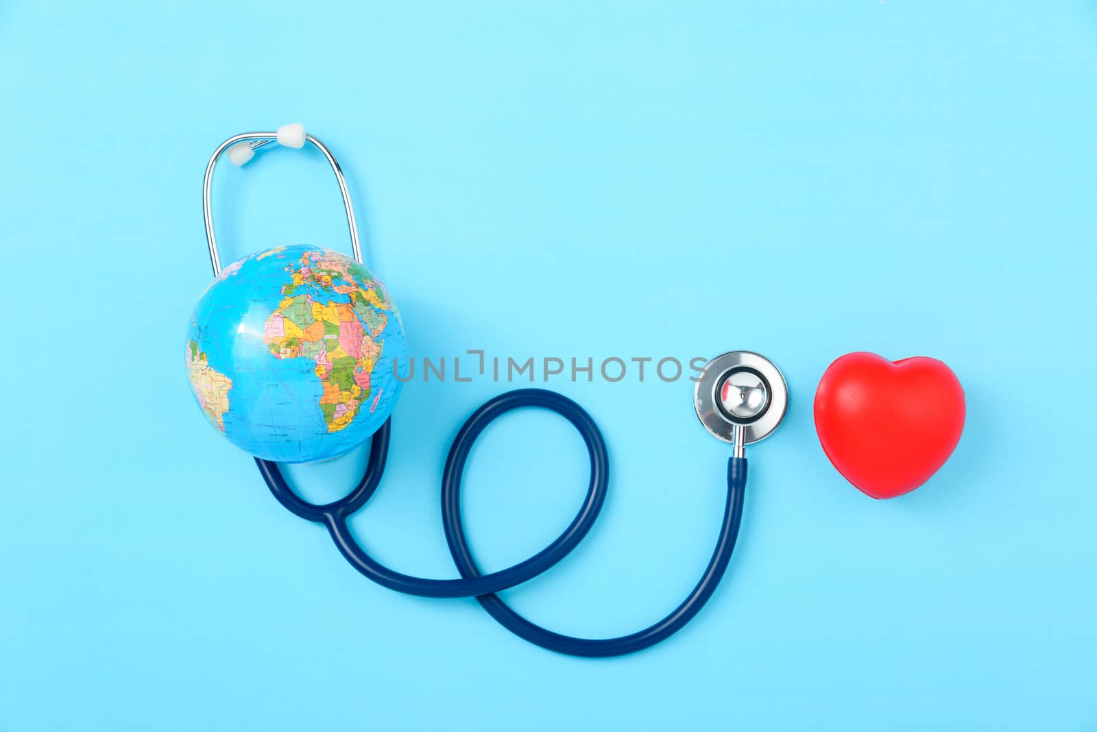 World health day concept, Stethoscope, globe and red heart on blue background with copy space. Global health care