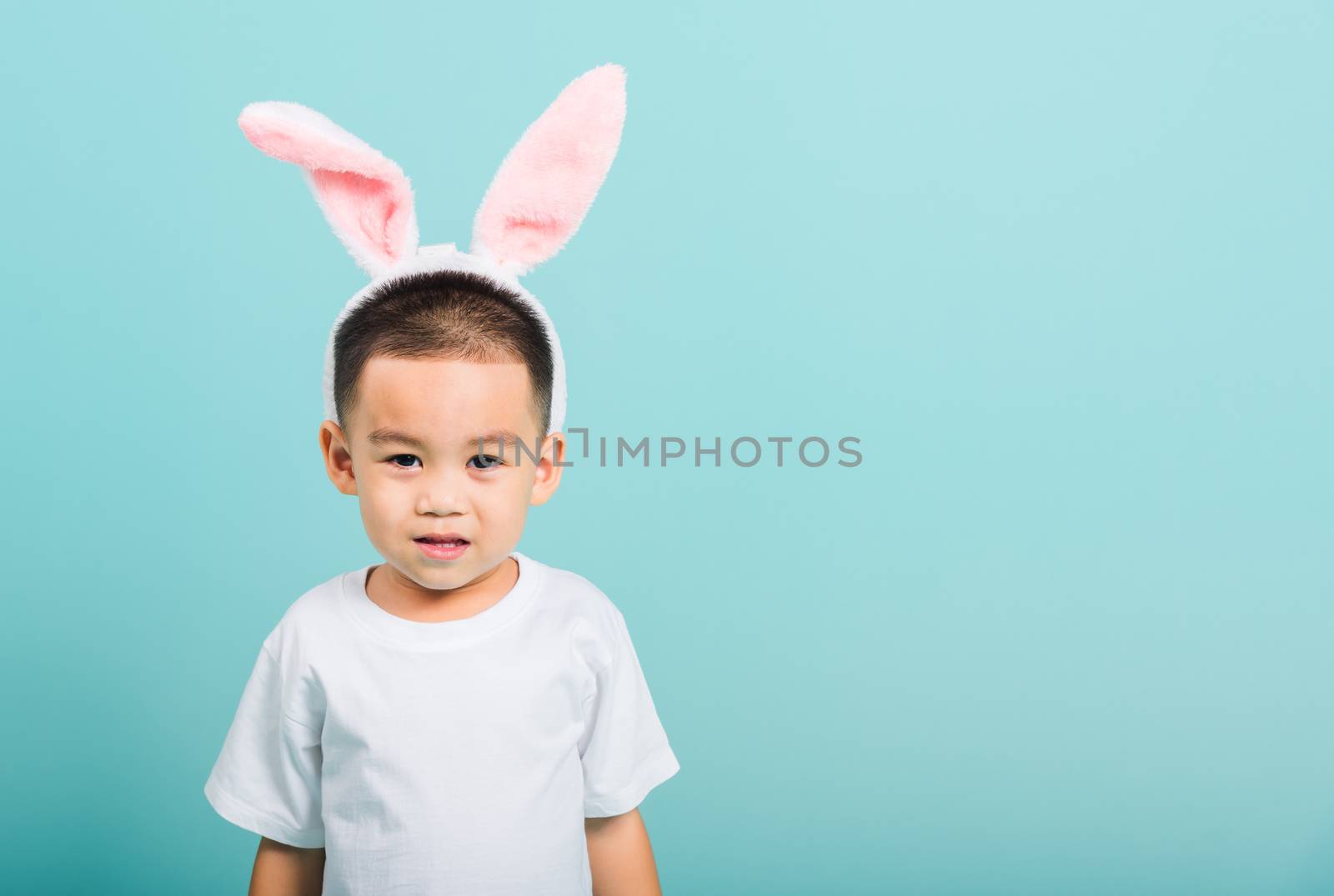 little child boy smile beaming wearing bunny ears by Sorapop