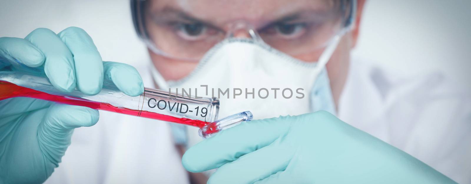 Coronavirus covid 19 infected blood sample in sample tube in hand of scientist with biohazard protection clothing in corona virus covid 19 research laboratory, coronavirus covid 19 vaccine research concept