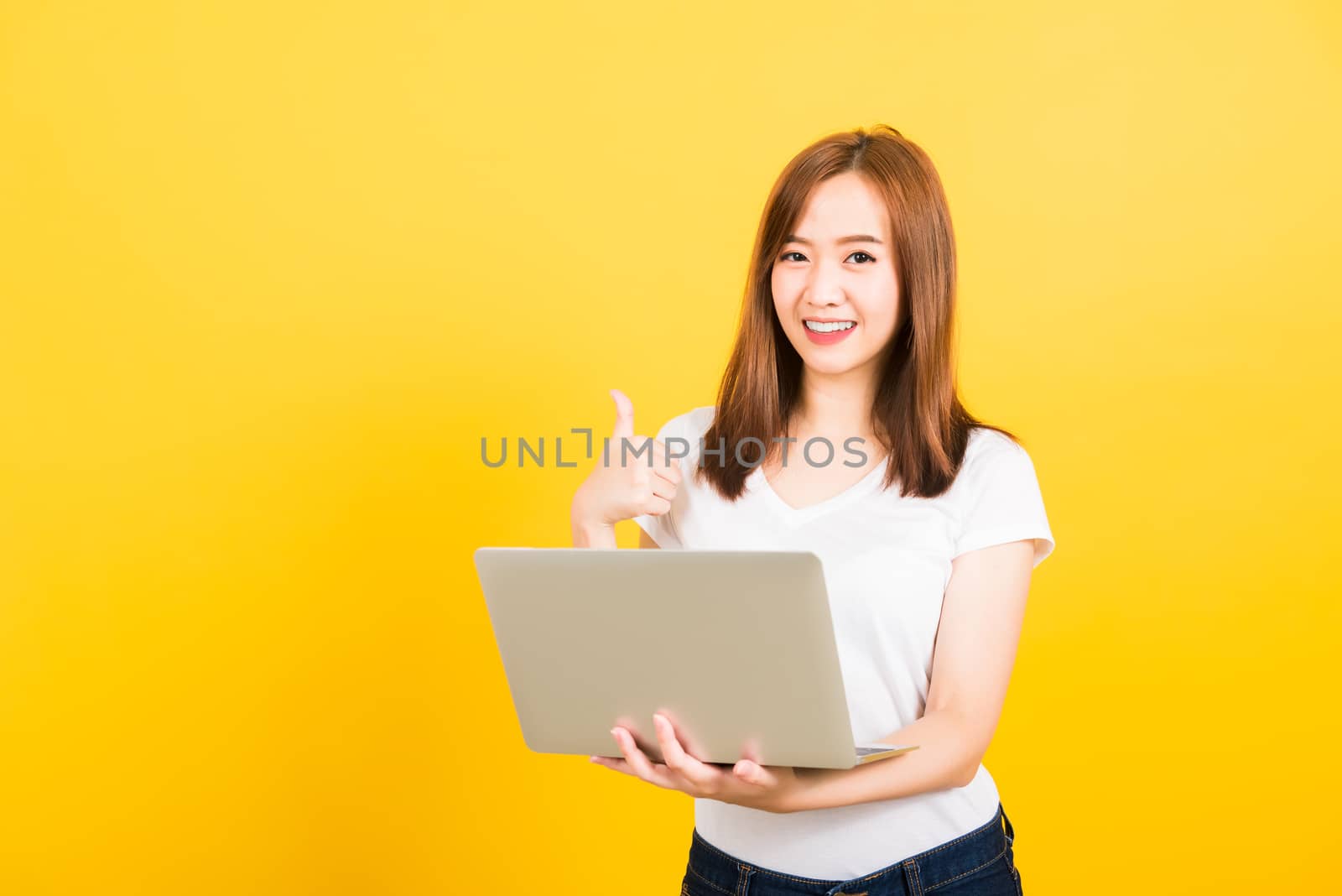 woman teen smiling standing wear t-shirt using laptop computer a by Sorapop