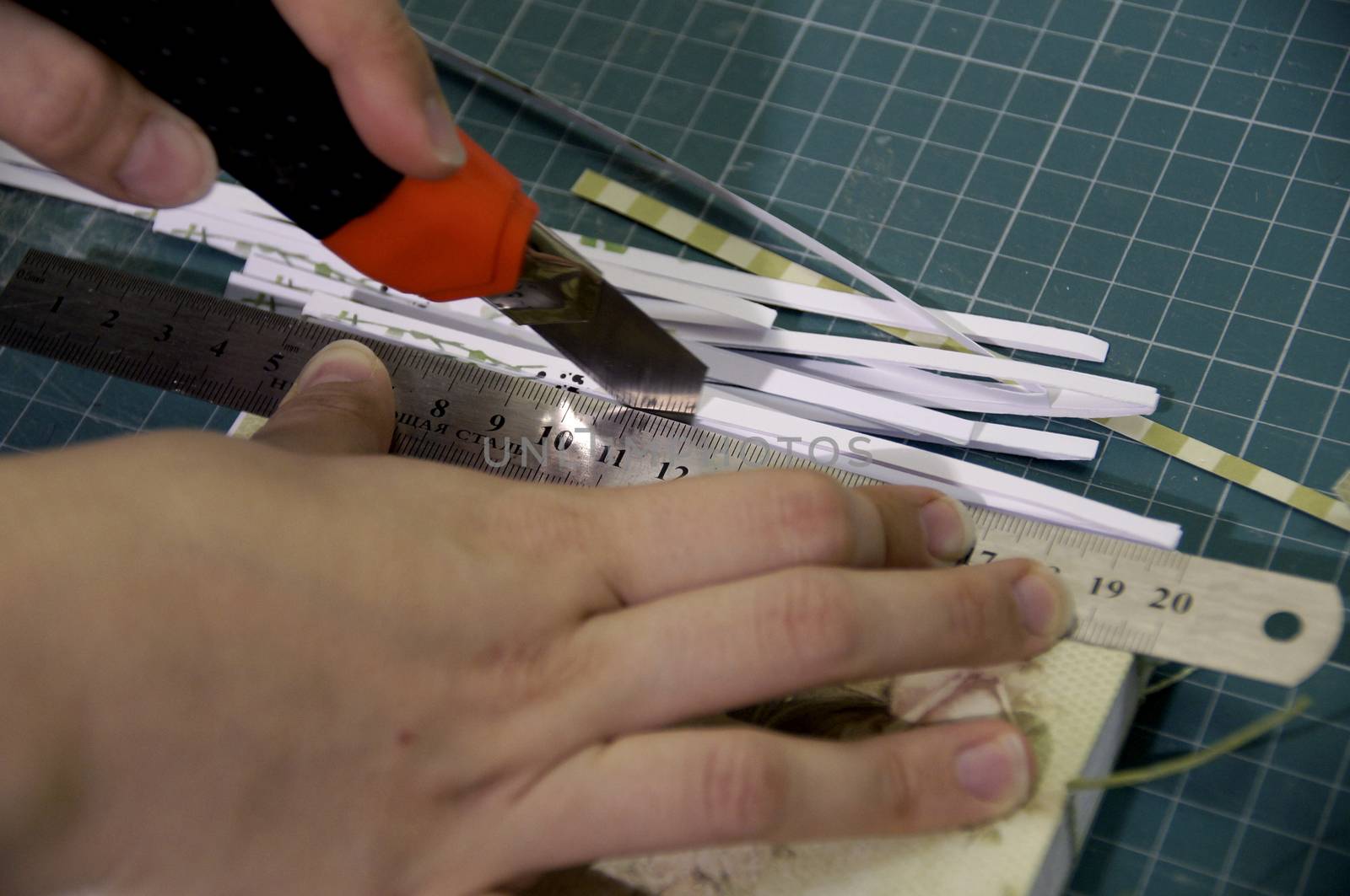 the process of handmade creating of the diary from special scrapbooking paper, paper flowers and other decorative elements