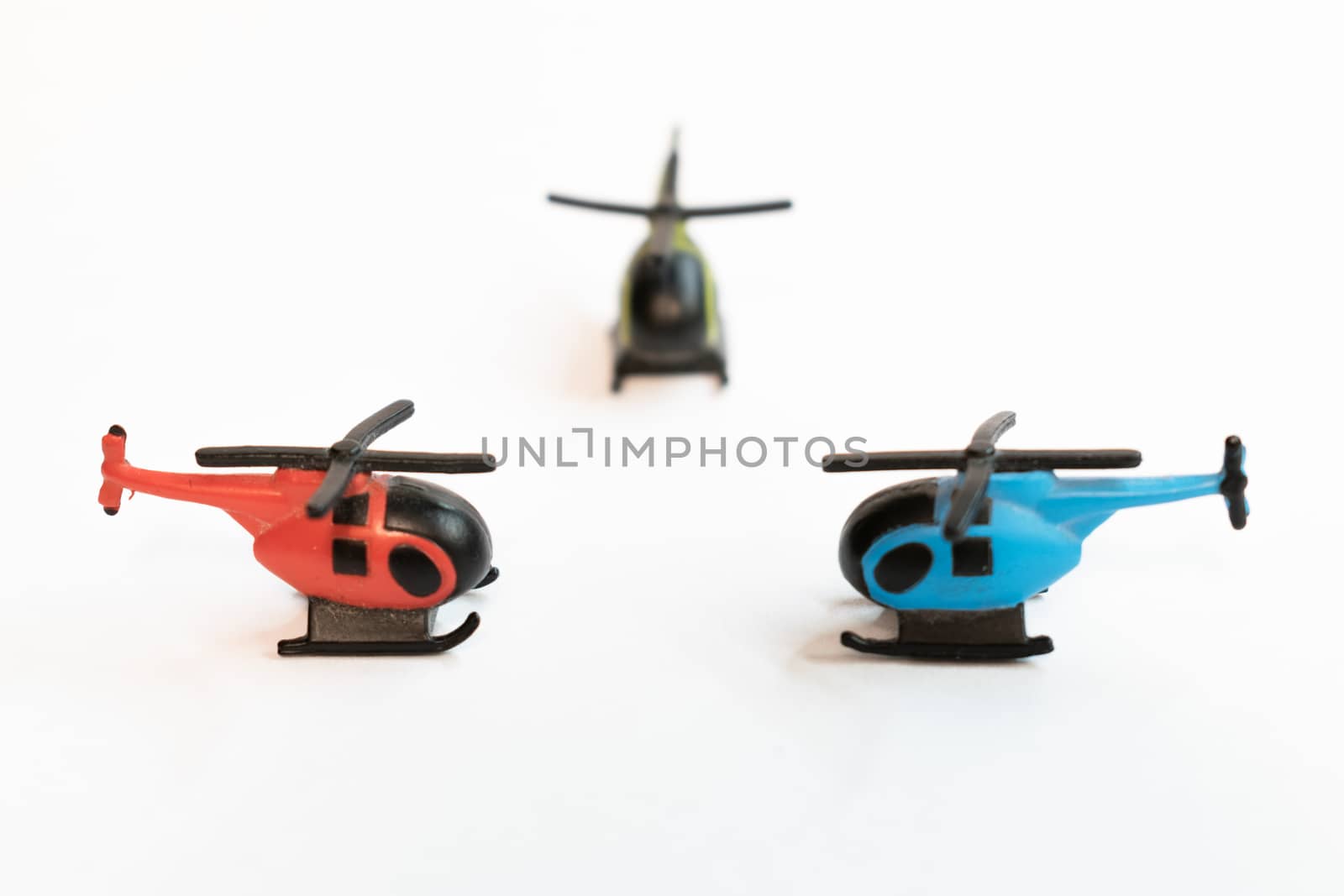 Small colorful helicopter toys isolated on a white background - air travel by helicopter concept.