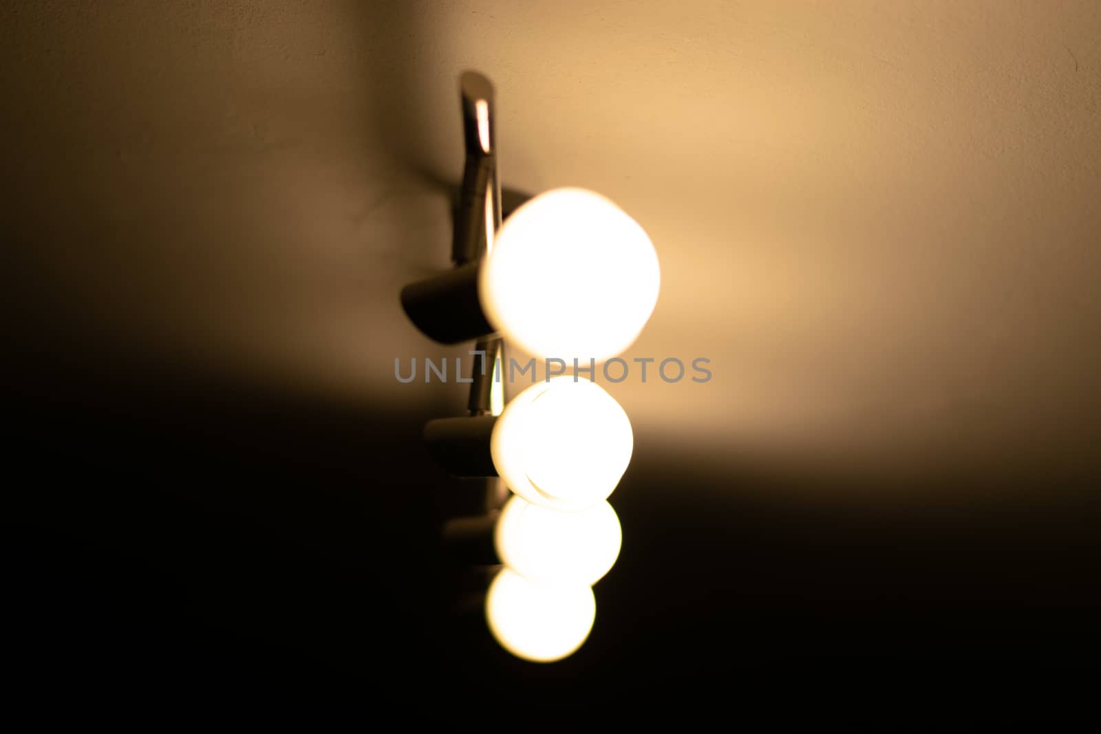 Some warm light bulbs mounted on a ceiling in a house - Electricity and illumination concept, Bucharest, Romania.