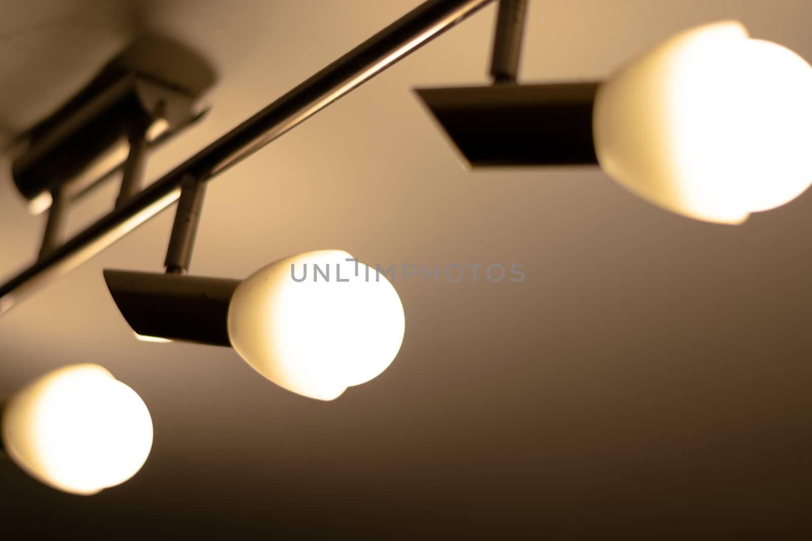 Some warm light bulbs mounted on a ceiling in a house - Electricity and illumination concept, Bucharest, Romania.