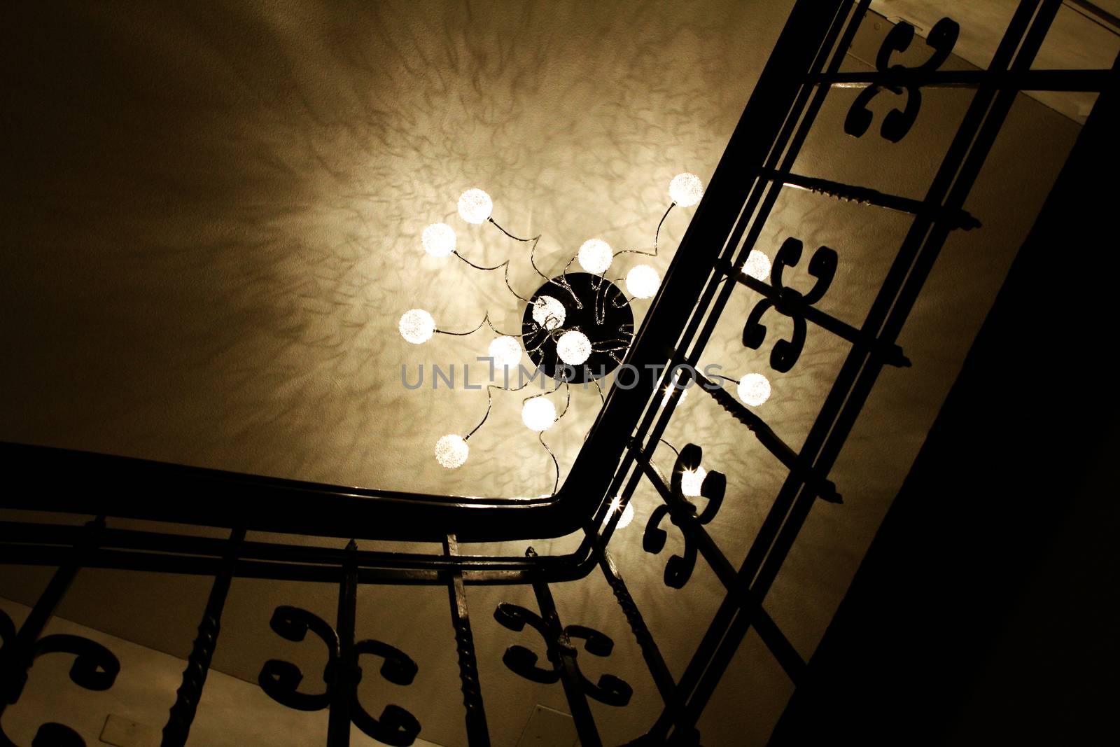 stair case with railing and fancy lamp in Luzern, Switzerland. Reflection on ceiling