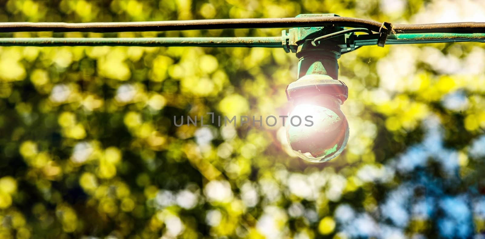 green painted light out in country side with bulb glowing