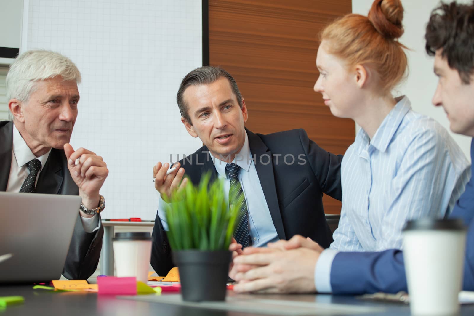 Working process at business meeting , people sitting around office table discussing ideas