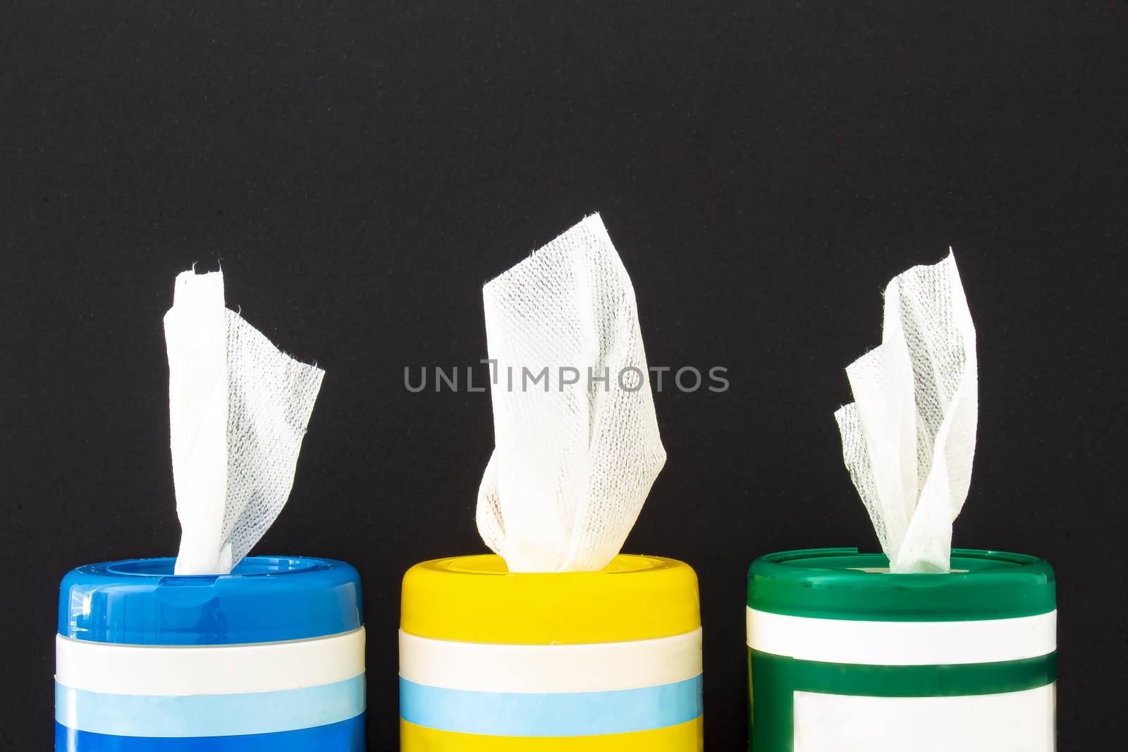 A close up of disinfecting wipes on a black background