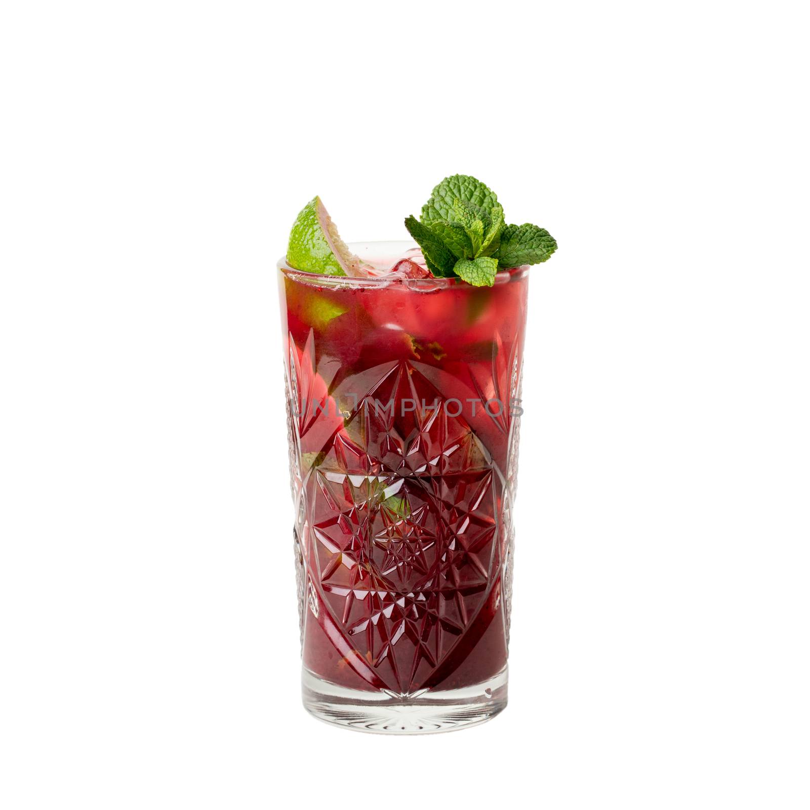 Cold multi fruit cocktail drink with slices of lime, mint leaf isolation on a white