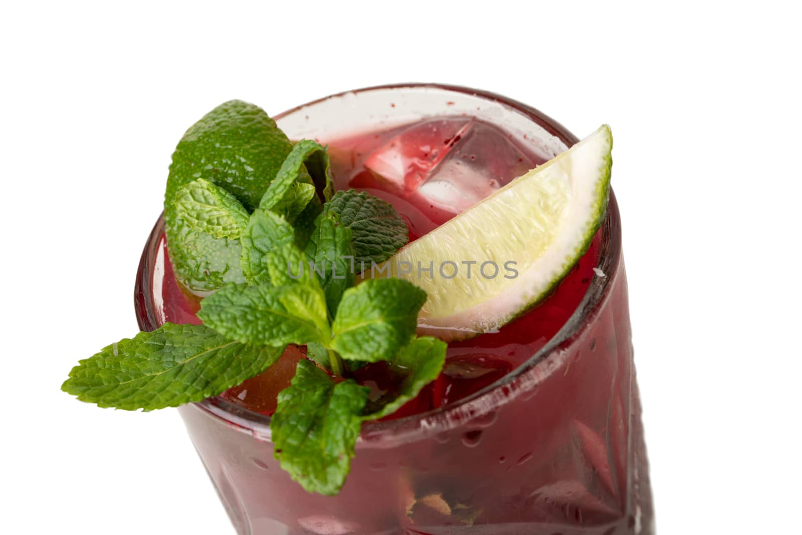 Cold multi fruit cocktail drink with slices of lime, mint leaf isolation on a white