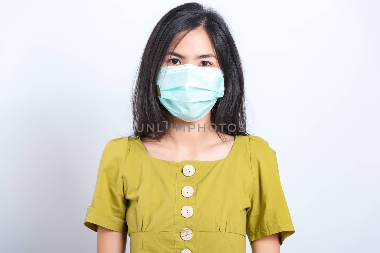 Portrait Asian beautiful happy young woman wearing face mask protects filter dust pm2.5 anti-pollution, anti-smog and air pollution on a white background, with copy space