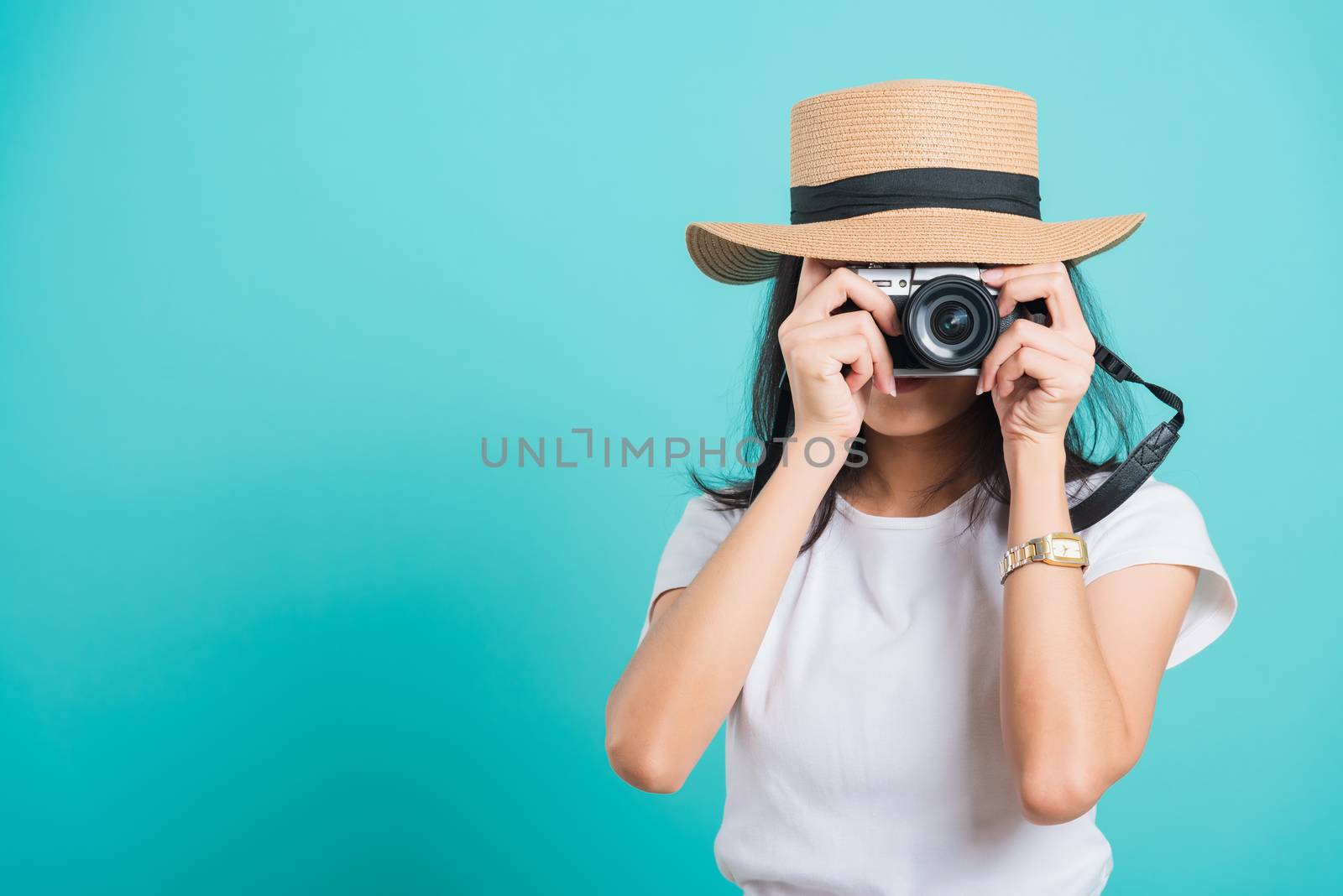 woman smile in summer hat standing with mirrorless photo camera by Sorapop