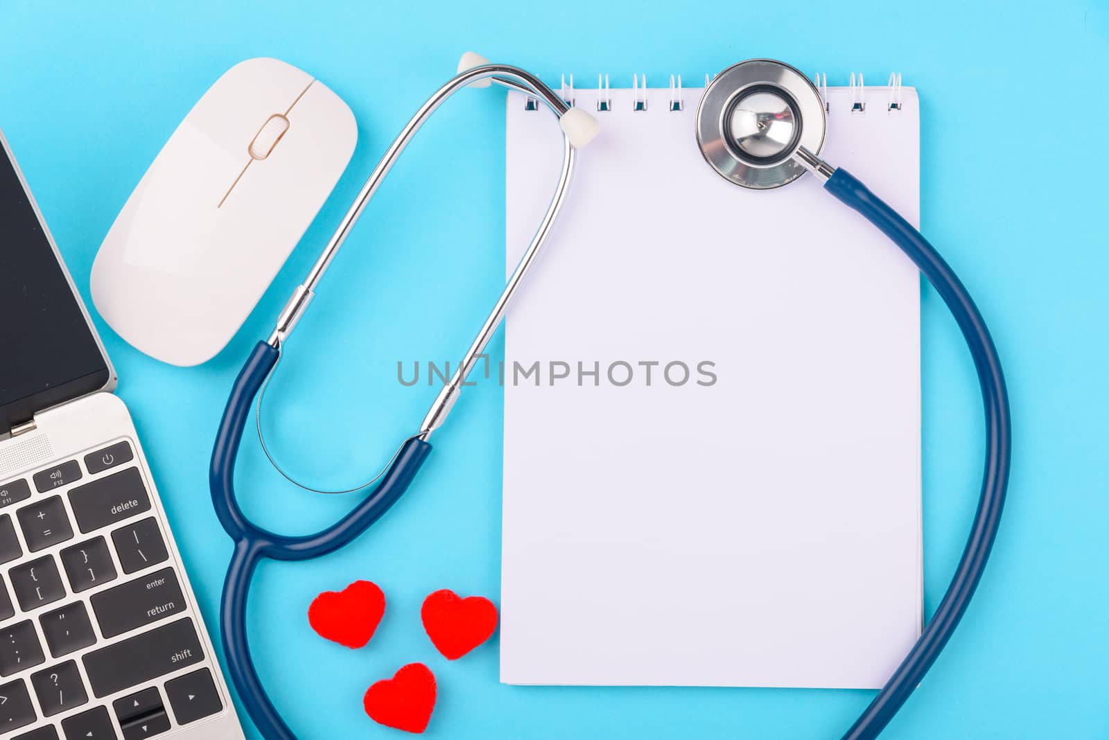 Doctor's Day concept, flat lay top view, stethoscope with peper note diagnosis of heart disease on blue background with copy space for text