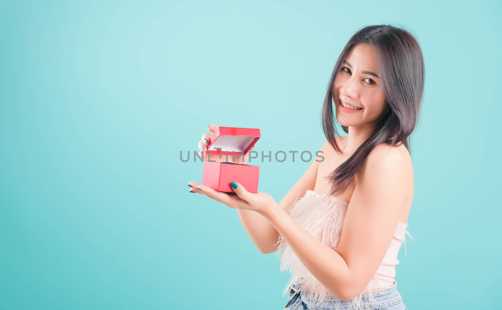 woman standing smile opening a red gift box, surprise birthday by Sorapop