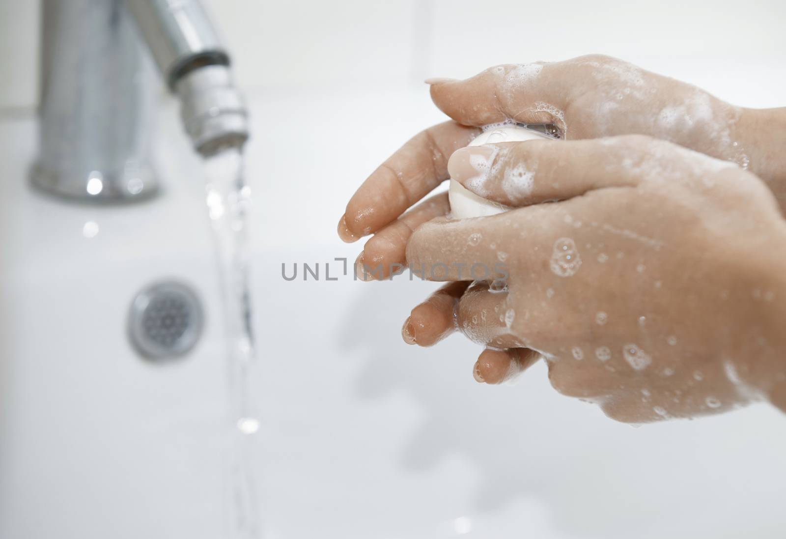 Woman washing hands with soap