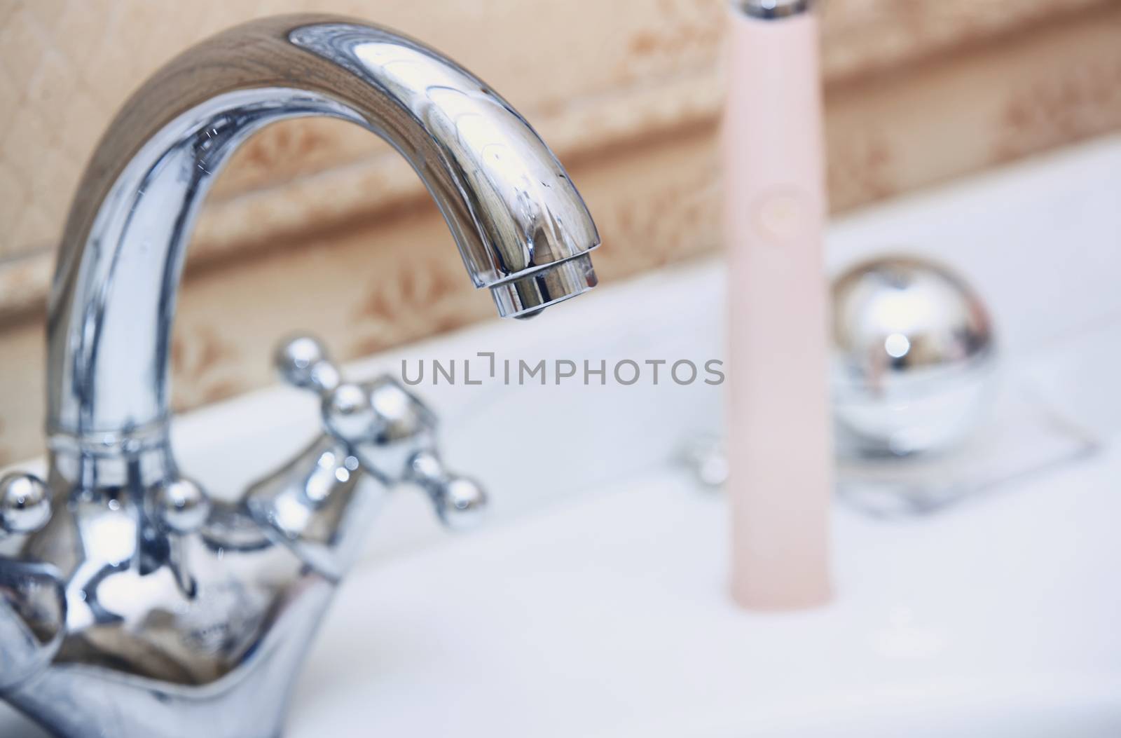 Close-up photo of the chrome water tap and sink