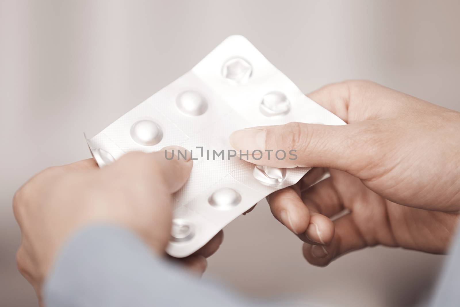 Hands of woman holding pack of medicament by Novic