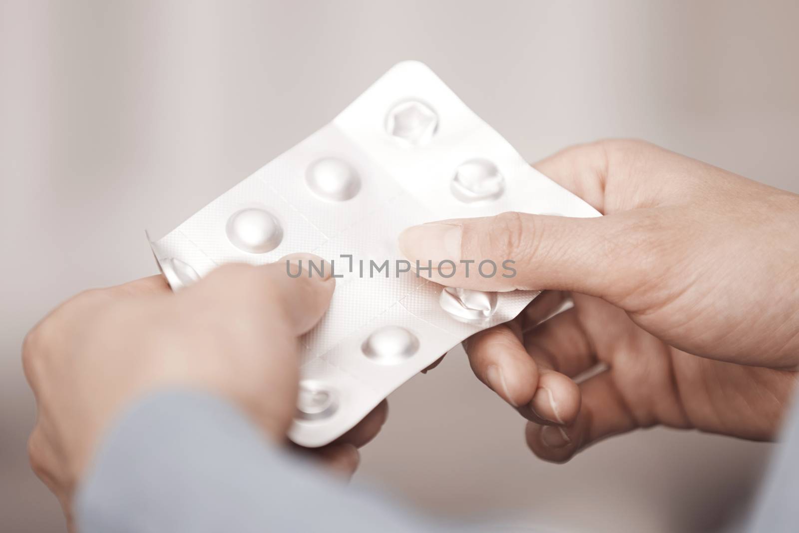 Hands of woman holding pack of medicament