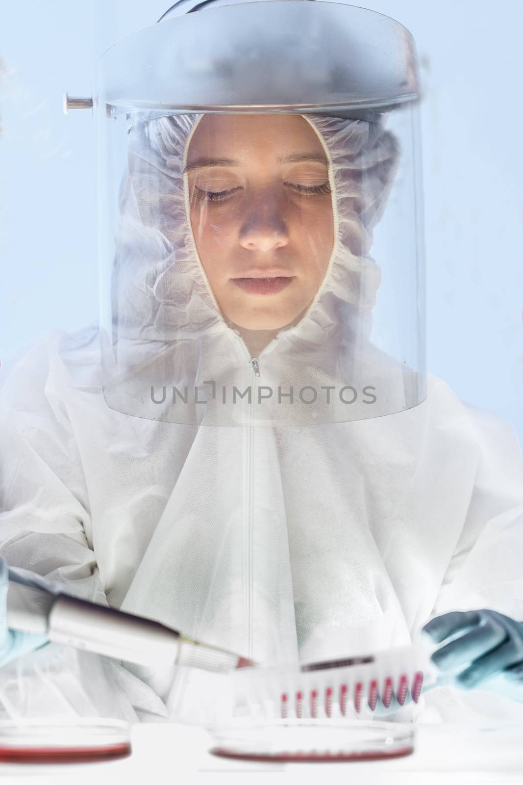 Scientist working in the corona virus vaccine development laboratory research with a highest degree of protection gear. Coronavirus pandemic concept. Development of virus treatment drug.