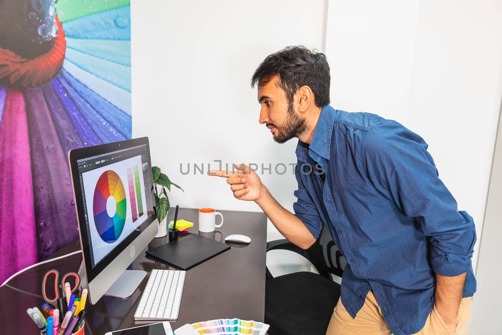Professional pointing at computer by bmphotographypty