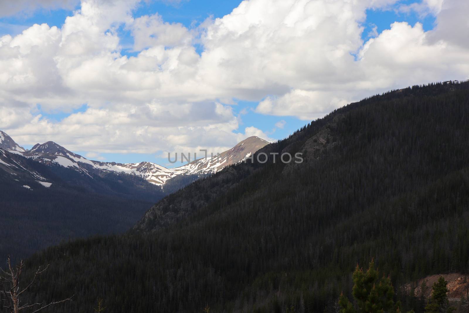 A summer time hiking view of the snow covered Colorado mountains by gena_wells