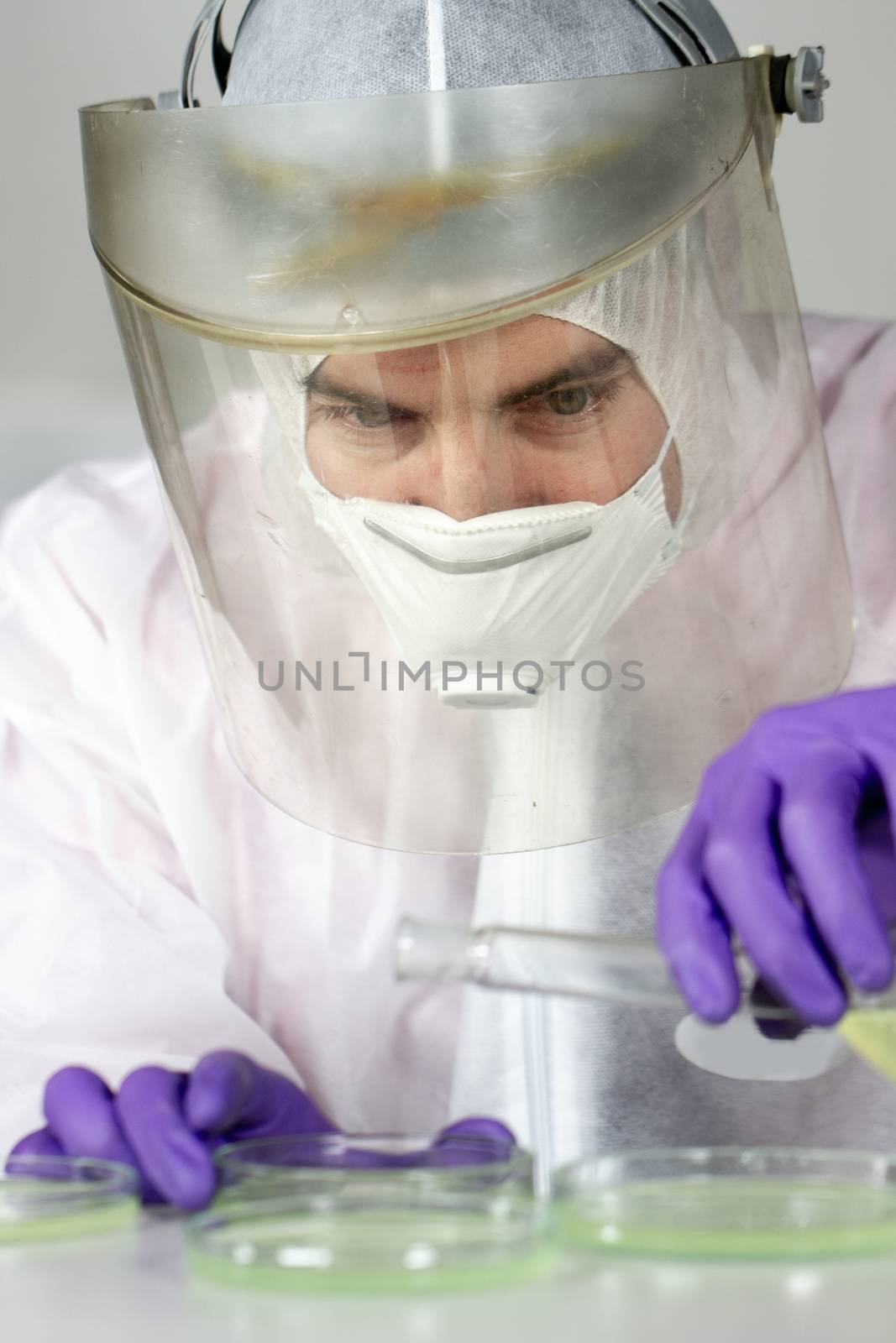 Scientist working in corona virus vaccine development laboratory research facility. by kasto