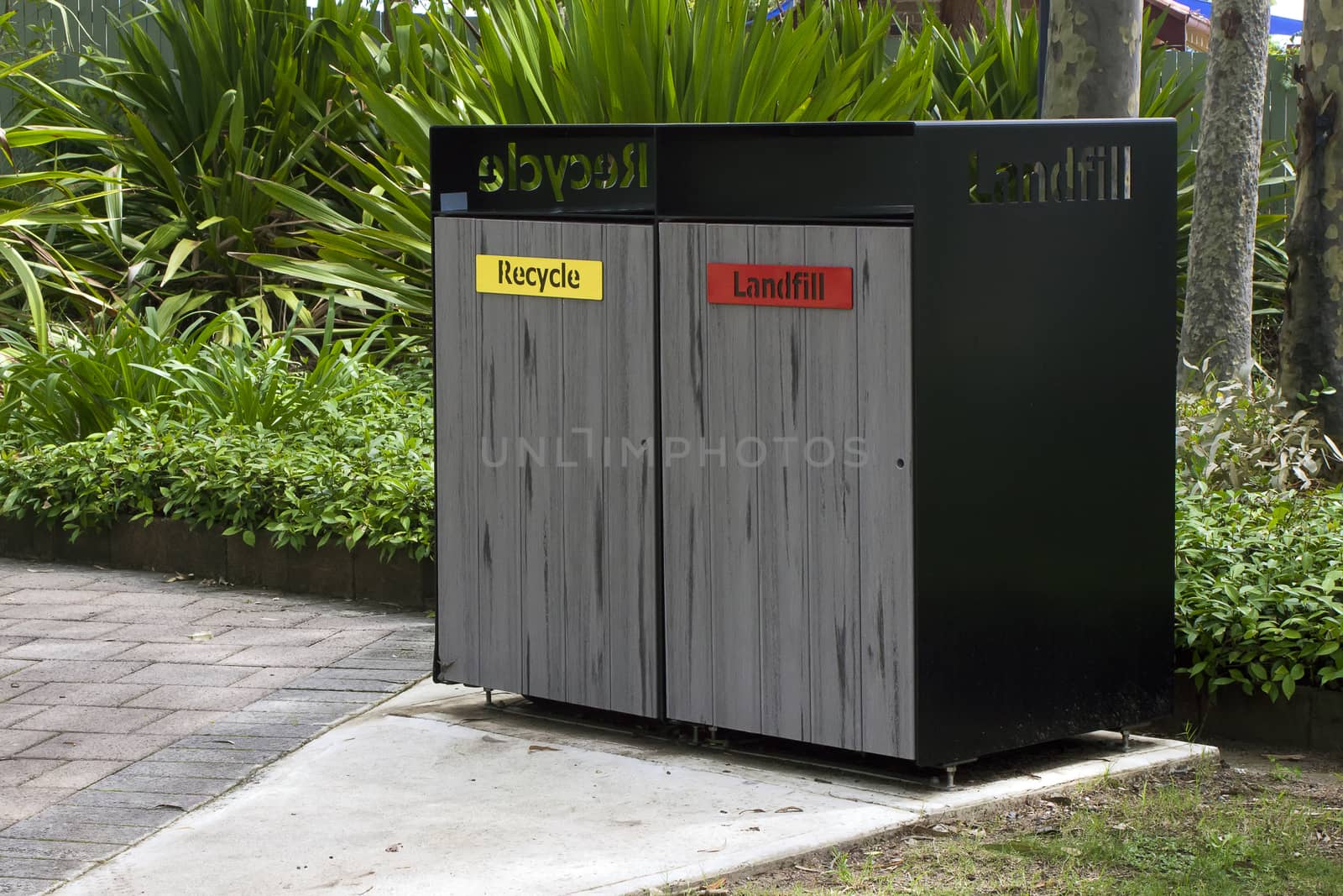 Waste bins enclosure for recycled waste and for landfill in a public park