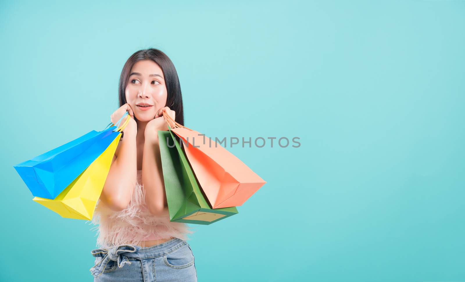 woman standing smile in summer shopping her holding multicolor s by Sorapop