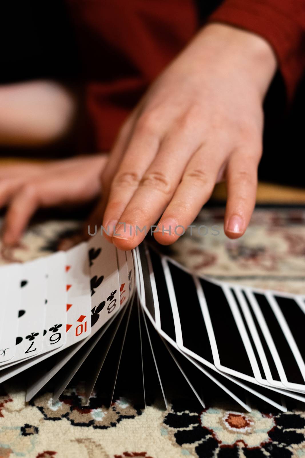 A person doing a ribbon spread with his playing cards