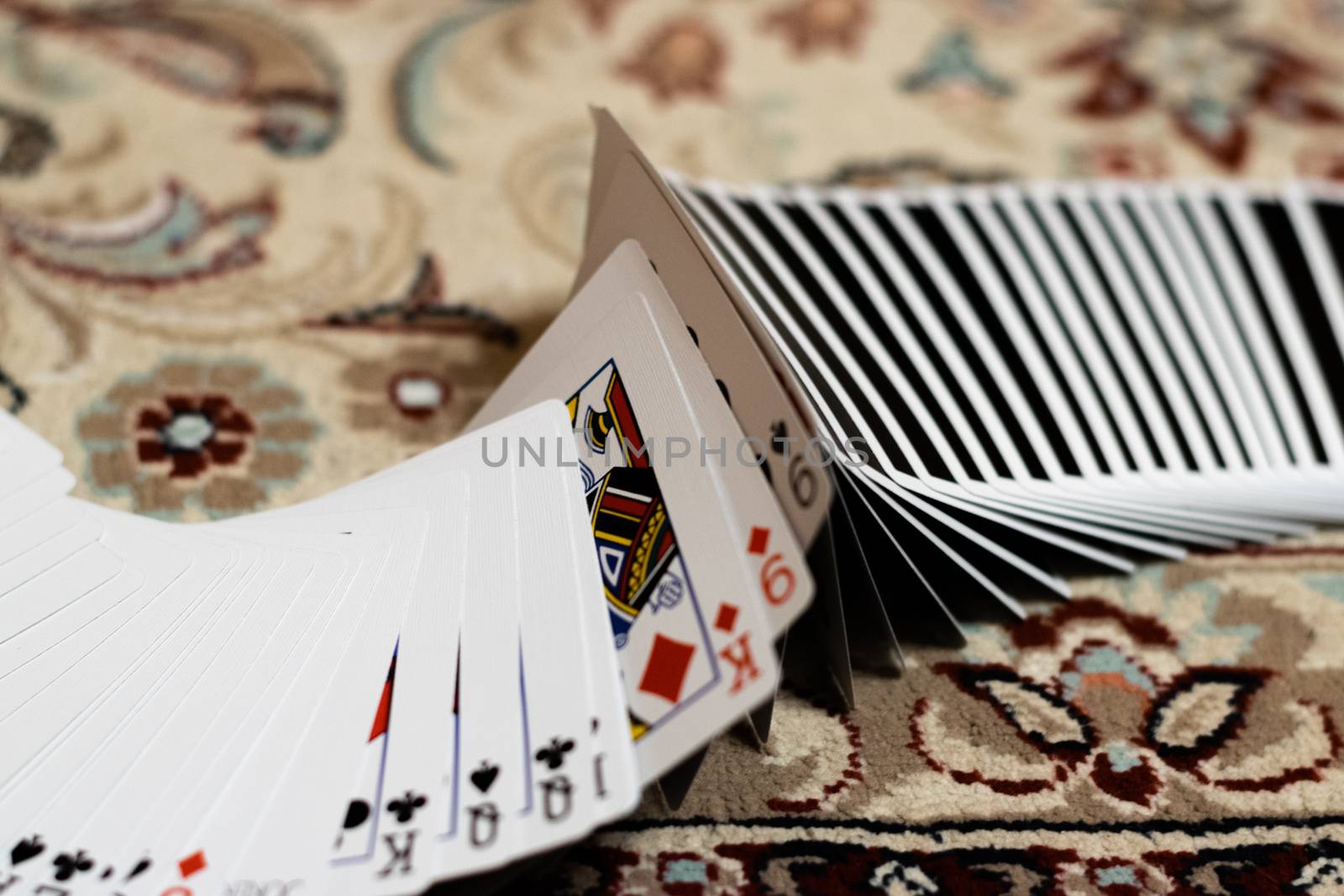 A deck of playing cards arranged like if doing a ribbon spread