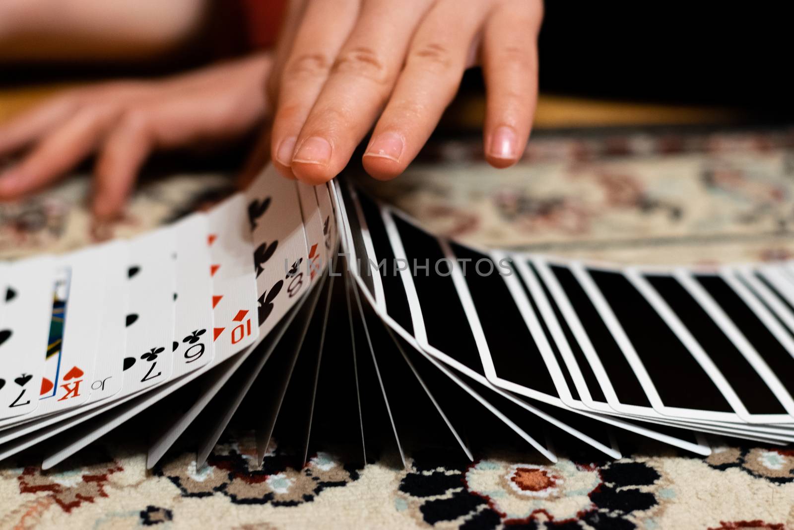 A person doing a ribbon spread with his playing cards