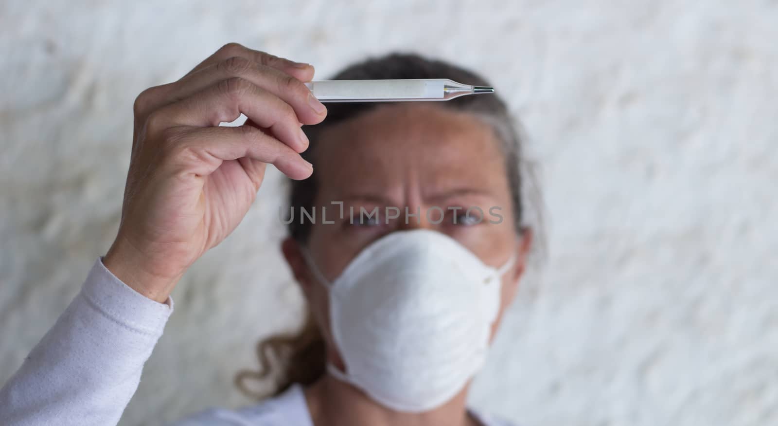 adult woman with thermometer and chinstrap in prevention of influenza virus and coronavirus by GabrielaBertolini