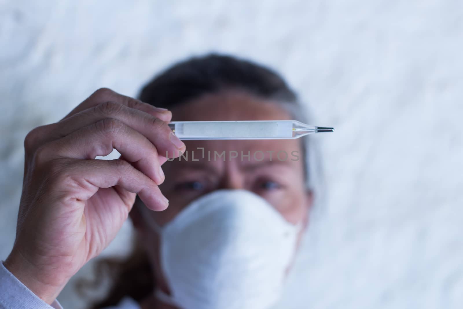 adult woman with thermometer and chinstrap in prevention of influenza virus and coronavirus