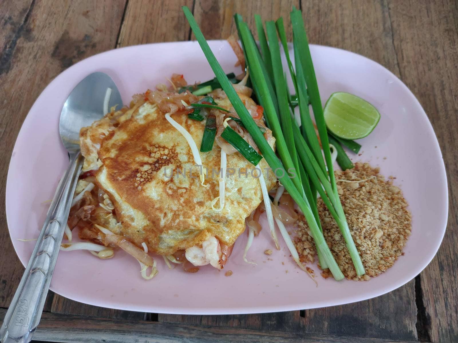 Pad Thai on pink disk, thai food by peerapixs