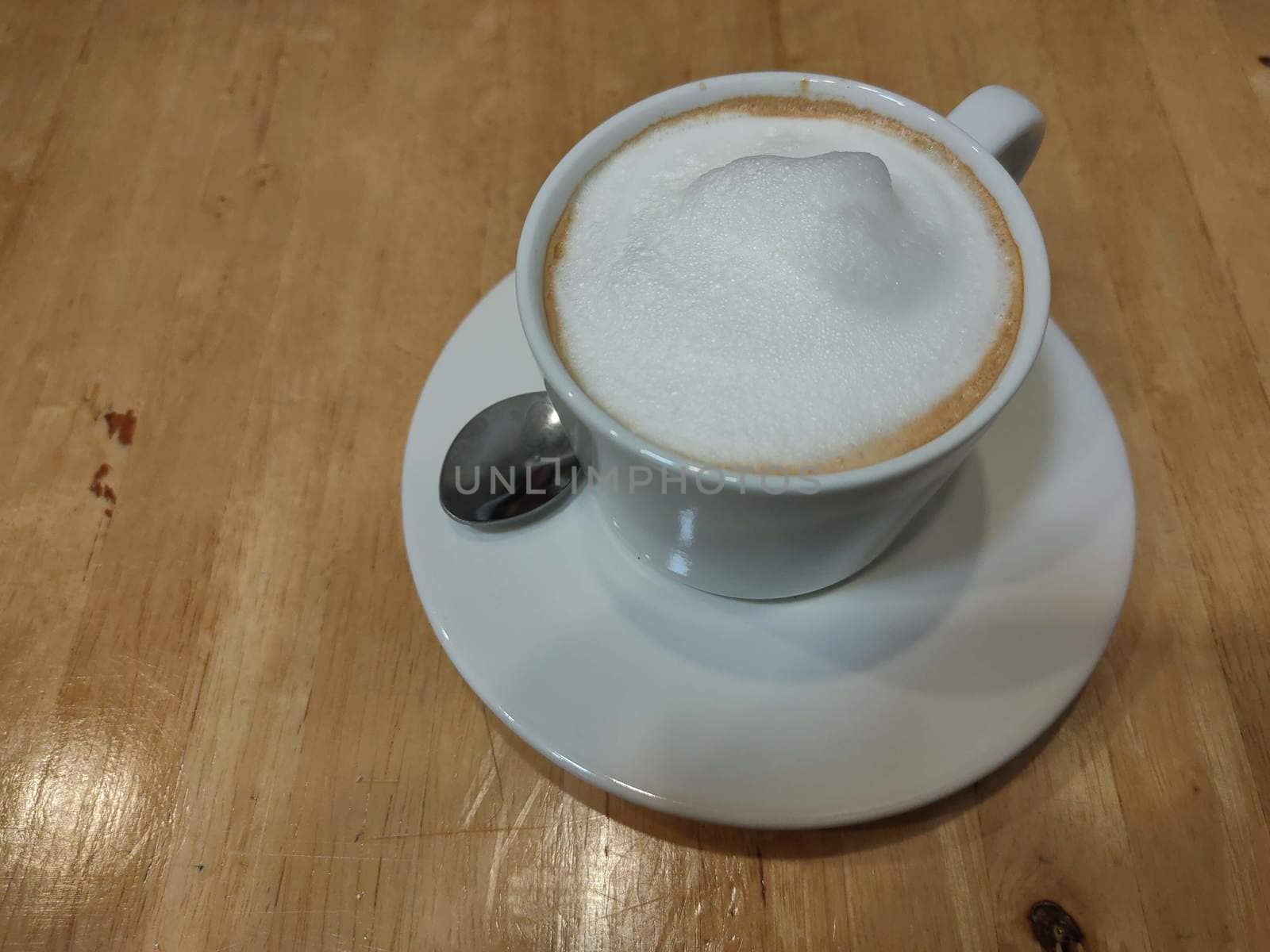 White Coffee cup on wooden table for background use by peerapixs