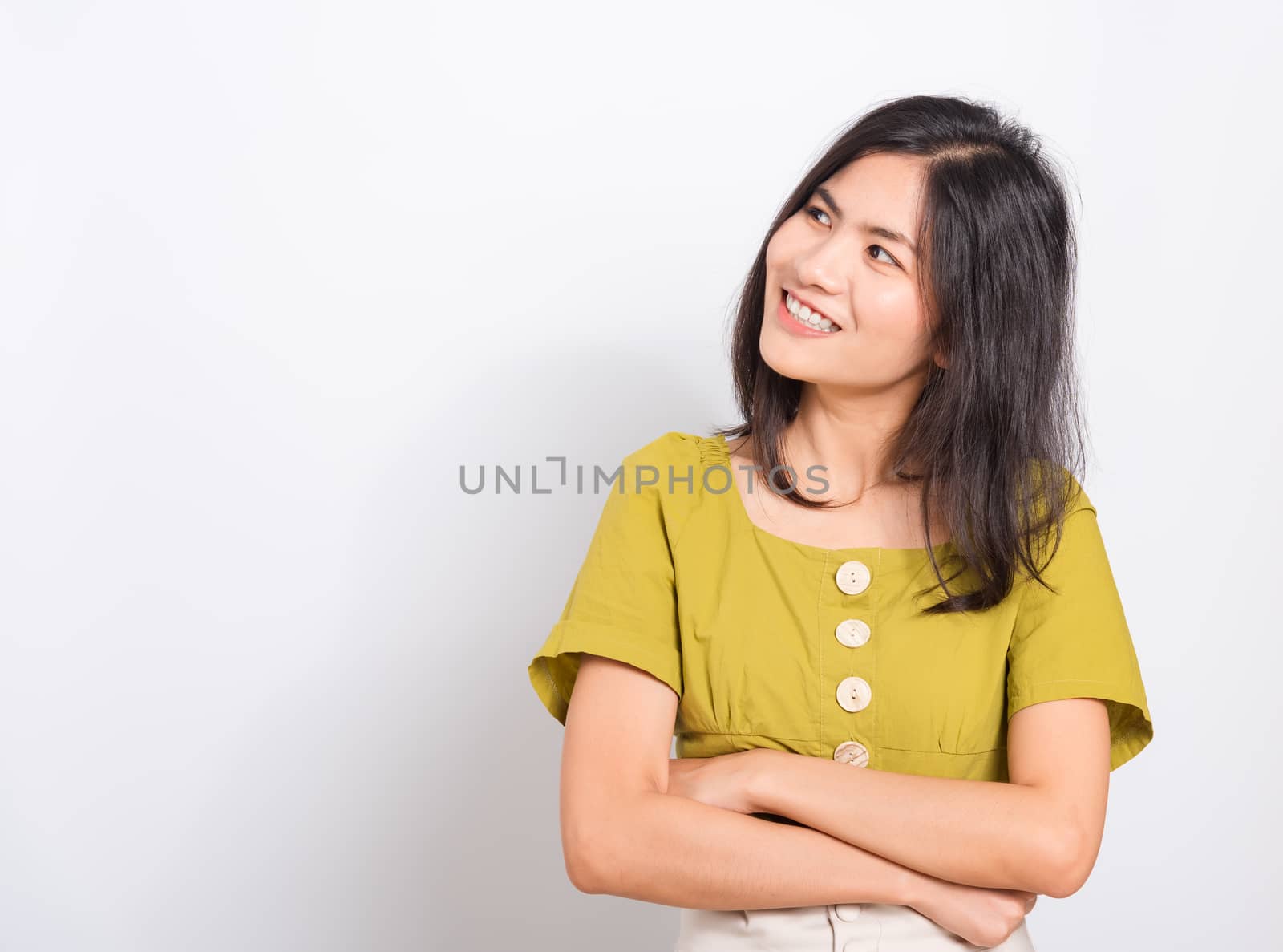 Portrait Asian beautiful young woman standing smile seeing white teeth, She crossed her arms and looking Above, shoot photo in studio on white background