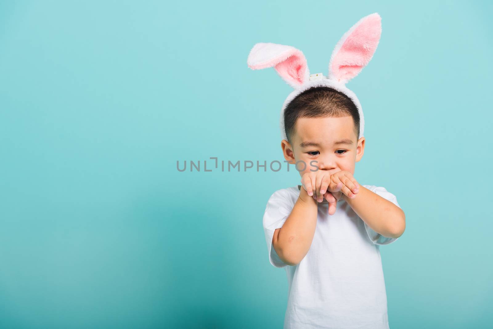 little child boy smile beaming wearing bunny ears by Sorapop