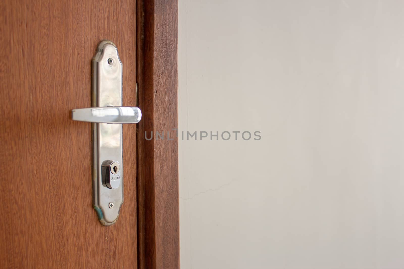 Door handle of a simple wooden door on the entrance of an apartment