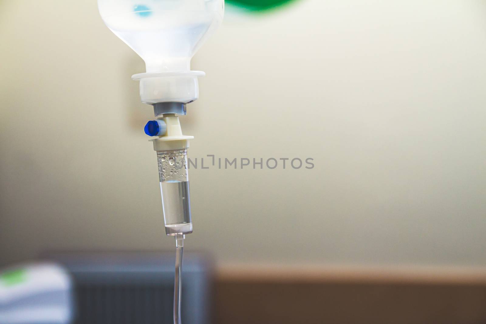 Set IV fluid intravenous drop saline drip in a hospital room. Close up, selective focus and copy space.