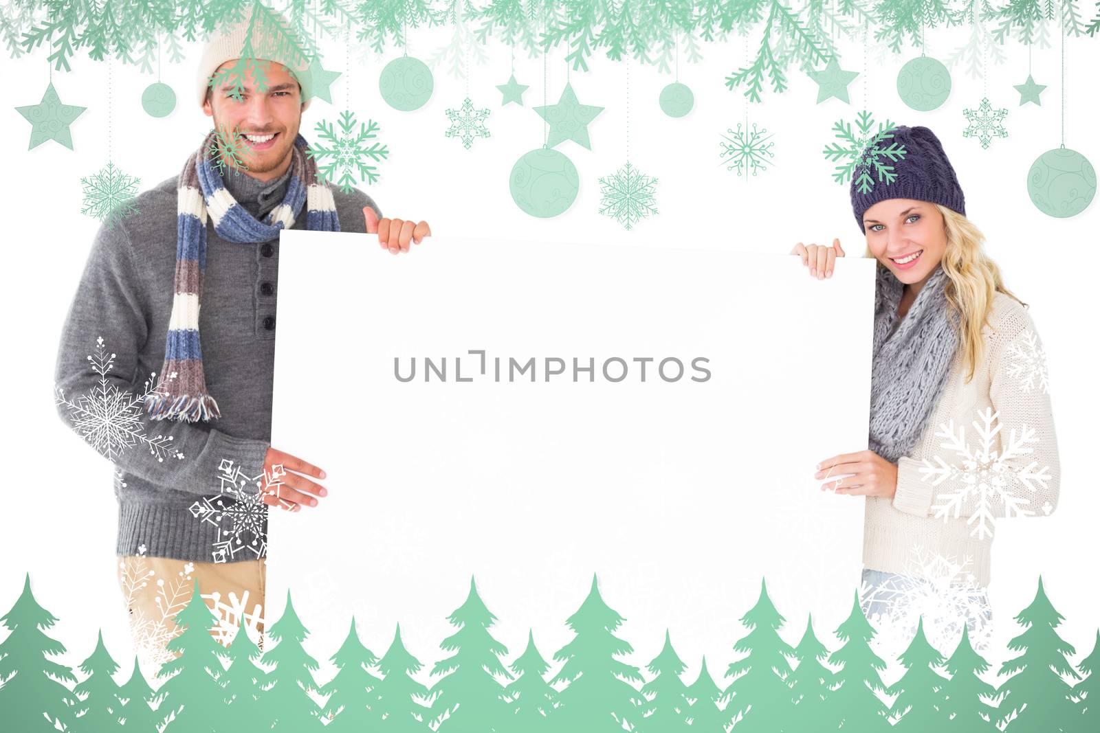 Composite image of attractive couple in winter fashion showing poster by Wavebreakmedia