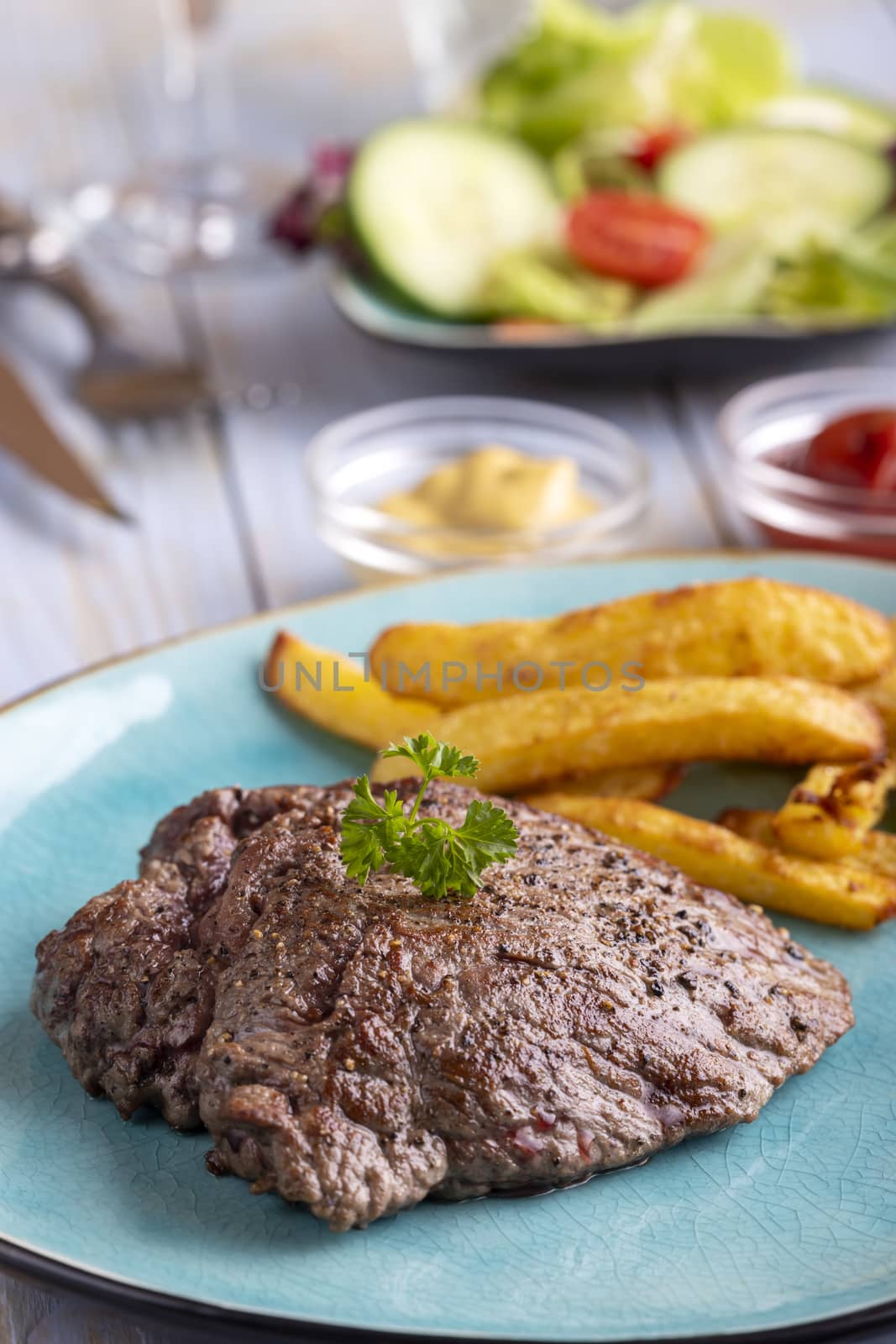 steak on a plate with french fries