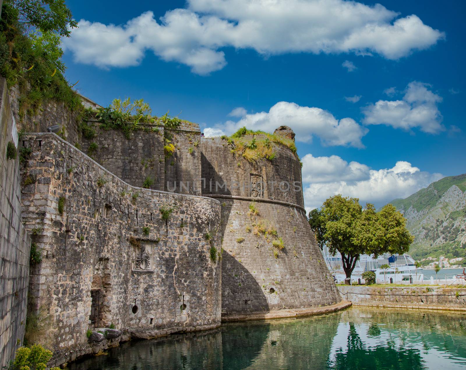 Stone Walls Over Bay in Kotor by dbvirago