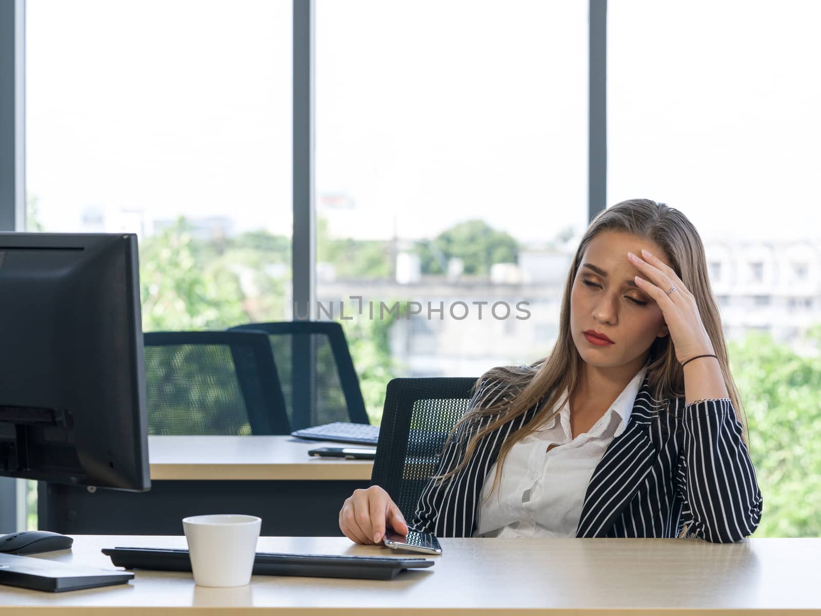Morning work atmosphere In a modern office. Teen employees rest her eyes due to dizziness and headaches. After clearing the remaining pending work.