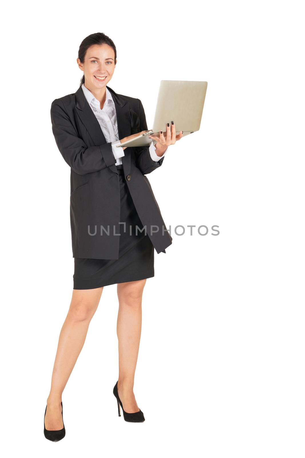 A business woman in a black suit with a smile and typing on a computer notebook. by chadchai_k