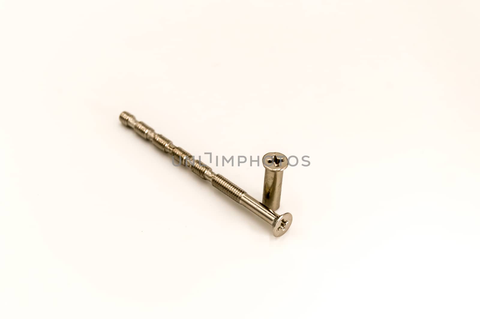 Screw and its metal door handle socket on a background on white