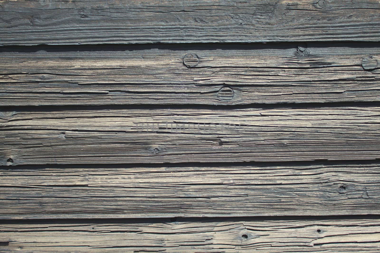 The picture shows a background with grey wooden boards