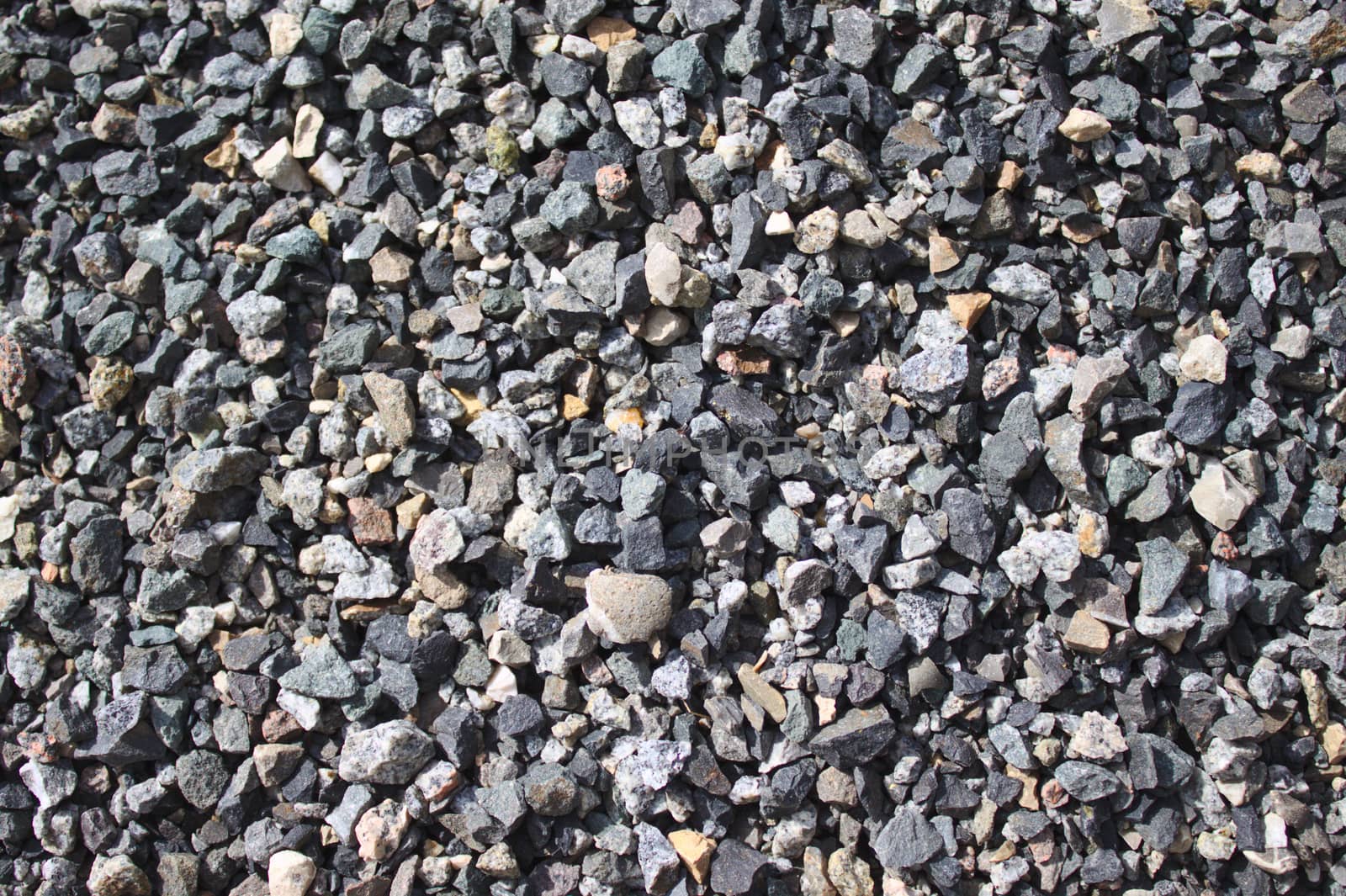 The picture shows a background with little grey stones