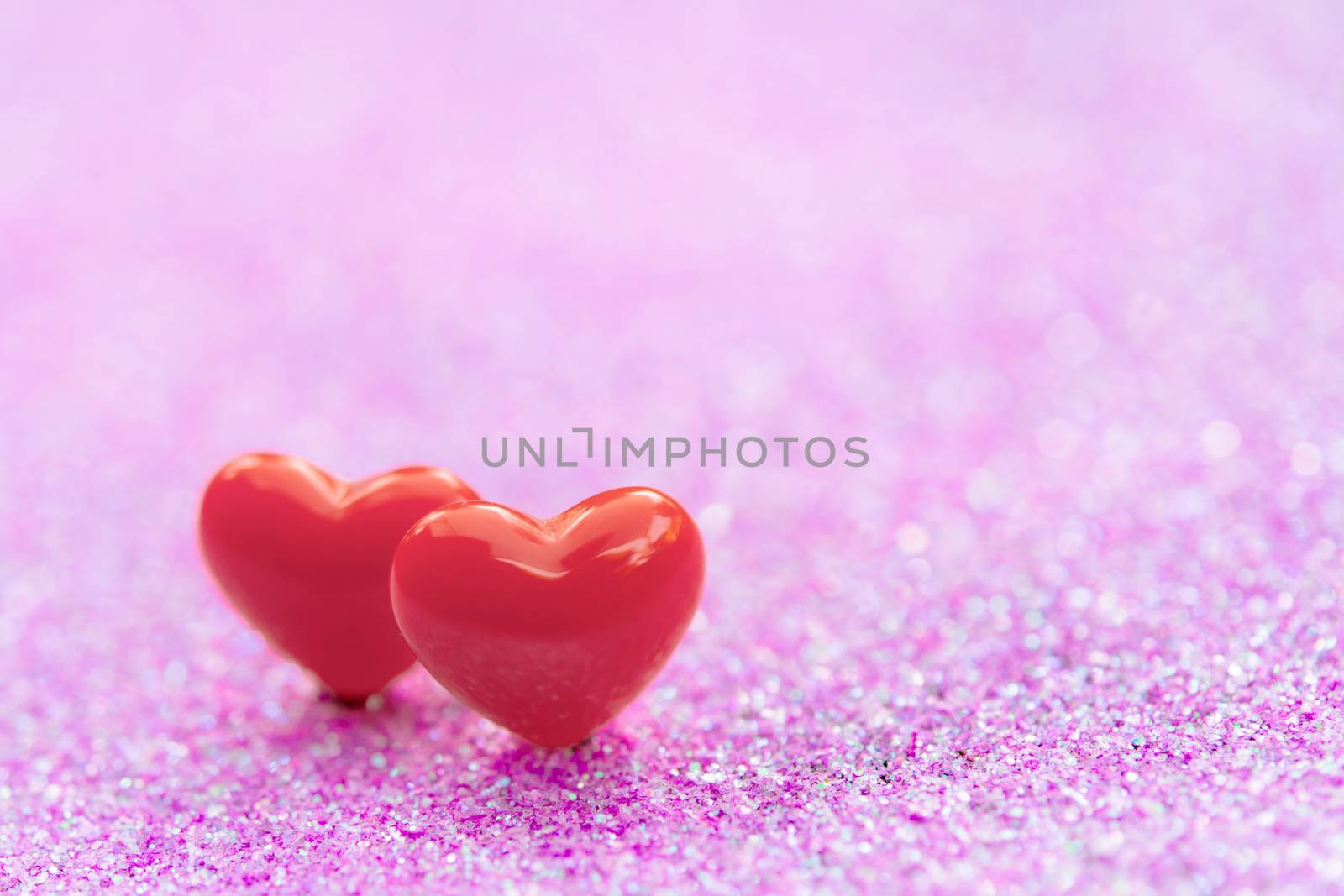 Valentines Day background with Red heart shapes on abstract light pink glitter background, Copy space