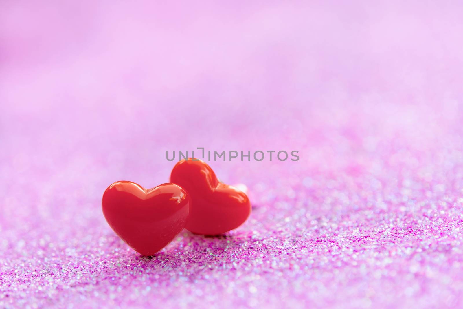 Valentines Day background with Red heart shapes on abstract light pink glitter background, Copy space