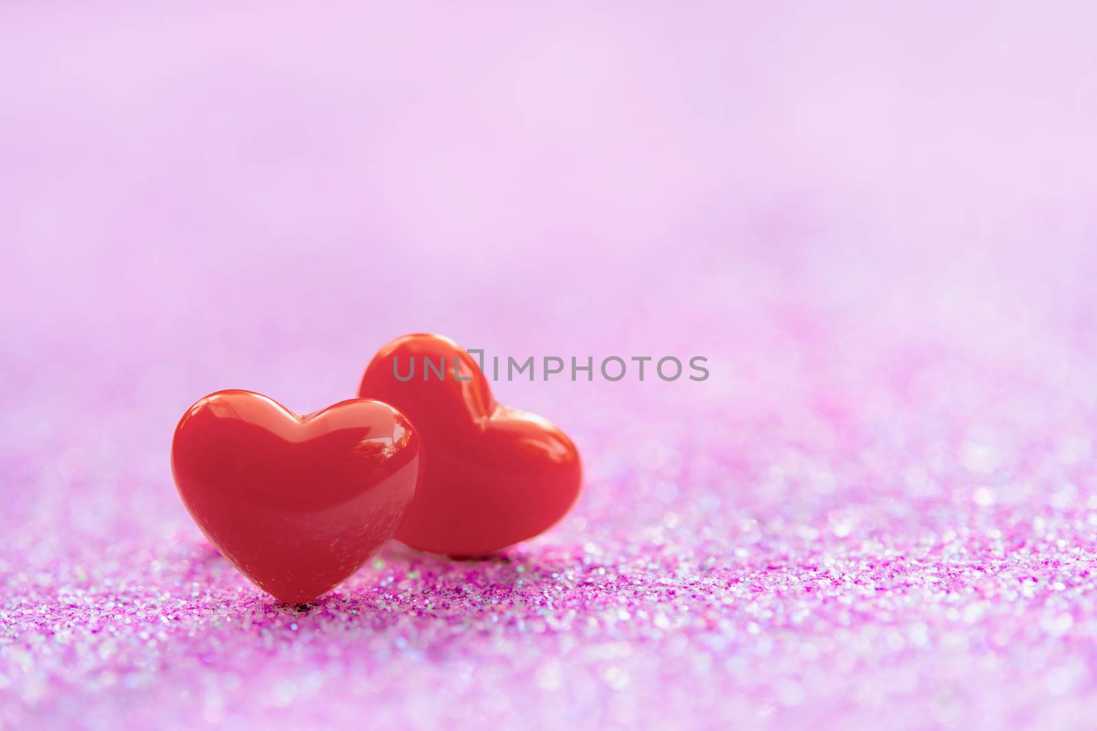Valentines Day background with Red heart shapes on abstract light pink glitter background, Copy space
